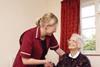 Social care worker helping older lady