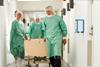 Patient on trolley being wheeled through corridor