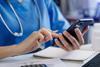 Medical technology concept. Doctor working with smartphone and stethoscope in office