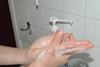 A woman washing hands with anti infection detergent