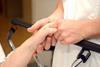 Patient bedside manner nurse holds patient hand