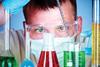 Man lookng closely at research chemicals