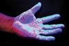 Hand hygiene: A hand under ultraviolet light to hightlight dirt