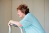 Elderly woman sitting with a zimmer frame