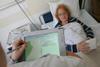 Mobile tablet being used in hospital to take patient record notes