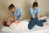 Patient being turned by two nurses