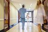 Blurred hospital corridor with three figures in it