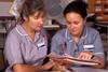 Two nurses talking about patient records