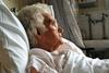 Elderly woman in hospital bed