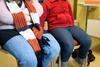 Two women sit in a waiting room