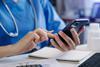 Medical technology concept. Doctor working with smartphone and stethoscope in office