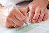 Woman's hands writing out a prescription