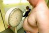 Obese man being weighed on scales
