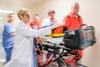 Paramedics wheeling patient in hospital-532049118