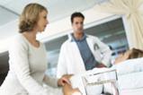 Doctor and nurse visit patient bedside in hospital