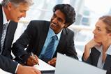 Three business people round a table