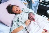 Baby and mother in maternity ward