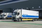 Picture of three NHS Supply Chain trucks waiting outside a warehouse.