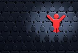 Man in spotlight standing out from crowd