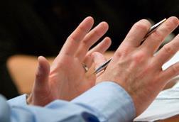 Gesticulating hands in meeting