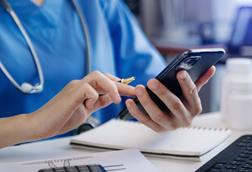 Medical technology concept. Doctor working with smartphone and stethoscope in office