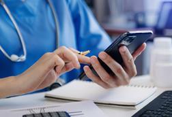 Medical technology concept. Doctor working with smartphone and stethoscope in office