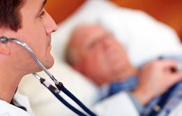 Old man in bed, doctor using stehoscope