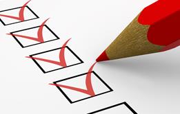 Red pencil marking ticks in boxes