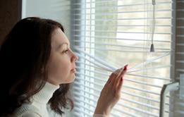 Young woman looking out window