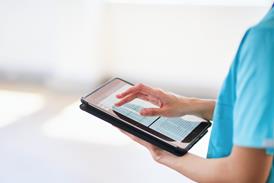 Medical Professional Using Tablet for Digital Health Records in Modern Hospital