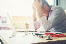 Stressed doctor with stethoscope