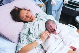 Baby and mother in maternity ward