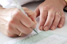 Woman's hands writing out a prescription