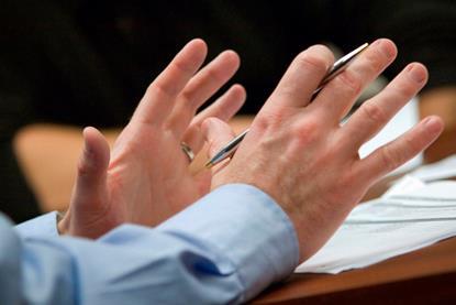 Gesticulating hands in meeting