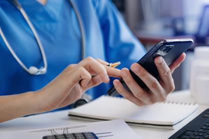 Medical technology concept. Doctor working with smartphone and stethoscope in office