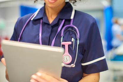 nurse close-up with tablet-926447760