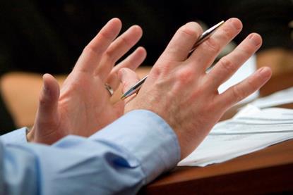 Gesticulating hands in meeting