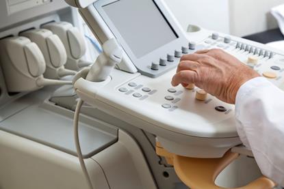 radiologist at ultrasound machine for scan