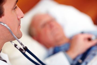 Old man in bed, doctor using stehoscope