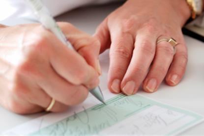 Woman's hands writing out a prescription