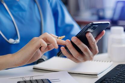 Medical technology concept. Doctor working with smartphone and stethoscope in office