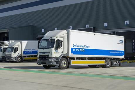 Picture of three NHS Supply Chain trucks waiting outside a warehouse.