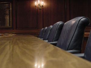An empty boardroom table and chairs