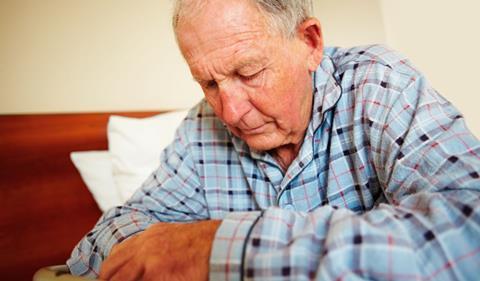 Elderly man, sitting on bed
