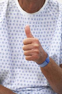 A happy patient thumbs up
