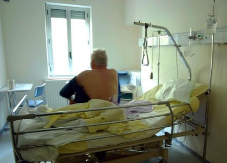 A patient sitting on the bed