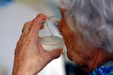 Older woman drinking water