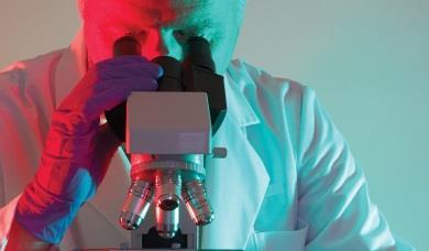 Man looking through microscope