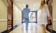Blurred hospital corridor with three figures in it