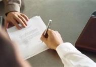 Man signing letter